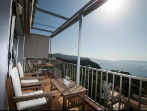a balcony with chairs and a table and a view of the ocean at SeaHomes Vacations, LA CASA BLUE Mediterranean Lifestyle in Blanes
