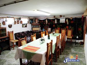 a dining room with a table and a couch at Elida Guest House in Shabla