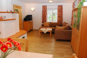 a living room with a couch and a table at Ferienhaus Becker in Schönau