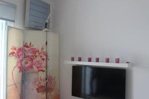 uma sala de estar com televisão e lareira em Casa da Praceta em Ponta Delgada