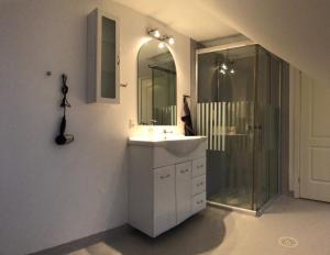 a bathroom with a sink and a shower at 103 Hvilestedvej in Fredericia