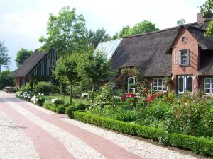 ein Haus mit Garten davor in der Unterkunft Nordsee-Paradies in Barlt