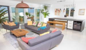 a living room with two couches and a table at SunsetLoft Vir in Vir