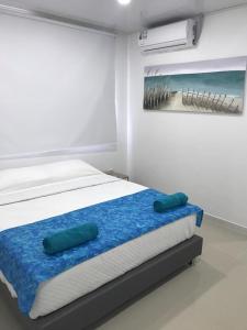 a bedroom with a bed with two pillows on it at Tropical Breeze Aeropuerto in San Andrés