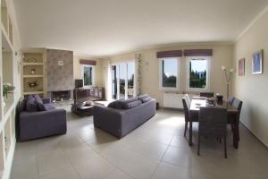 a living room with couches and a dining room at Anatoli Villa in Agia Effimia