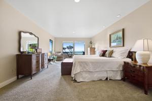 a bedroom with a large bed and a mirror at Sunset Point in Fort Bragg