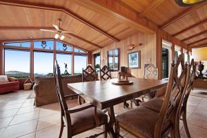 a dining room with a wooden table and chairs at Sunset Point in Fort Bragg