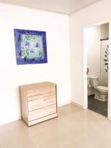 a bathroom with a cabinet and a toilet in a room at Tropical Breeze Aeropuerto in San Andrés