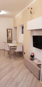 a living room with a table and chairs and a television at Karina House - Como in Como