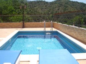 a swimming pool with a table and chairs in it at The Love Holiday House in Tris Elies +47 photos