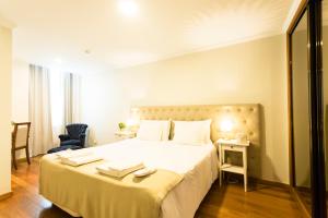 a hotel room with a bed and a dresser at Ericeira Soul Guesthouse in Ericeira