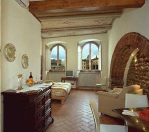 a living room filled with furniture and a large window at La Corte Del Re in Arezzo