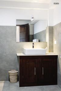 a bathroom with a sink and a mirror at Ayana Beach in Ja-Ela