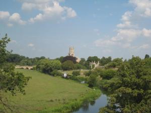 a view of a river with a castle in the distance at Castle Farm Guest House in Peterborough