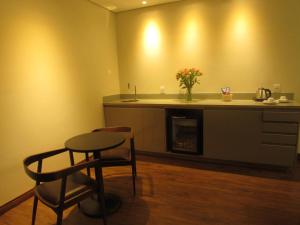 a kitchen with a table and a counter with a table at Pousada Contos de Minas in Mariana