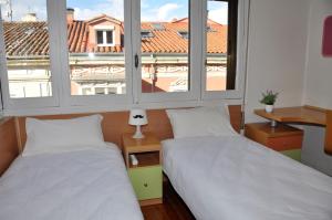 Łóżko lub łóżka w pokoju w obiekcie VillaDel Casa Urbana