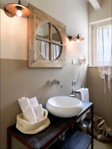 a bathroom with a sink and a mirror at Residence Relais Cà dell'Era in Tremosine Sul Garda