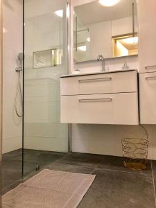 a bathroom with a sink and a mirror at Bee Amsterdam - central apartment in the trendy Jordaan in Amsterdam