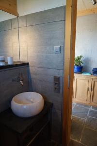 a bathroom with a bowl sink on a counter at CaLegna Ferienchalet in Bad Kohlgrub