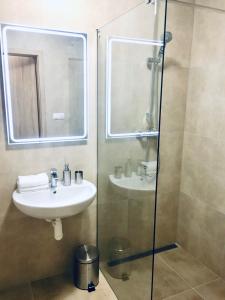 a bathroom with a sink and a shower with a mirror at Apartment No.7 Lúčky - Jasná in Belá