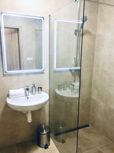 a bathroom with a sink and a shower with a mirror at Apartment No.7 Lúčky - Jasná in Demanovska Dolina