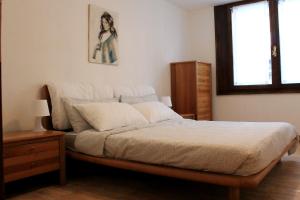 En eller flere senger på et rom på Trentino Apartments - Casa Corn