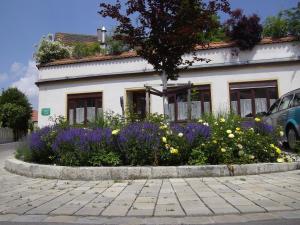 a house with a flower bed in front of it at CasaCreativa in Bad Windsheim