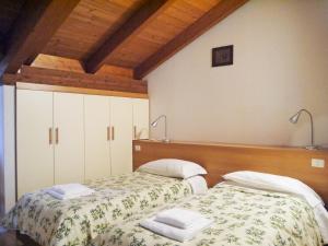 2 nebeneinander sitzende Betten in einem Schlafzimmer in der Unterkunft Hotel Oasi in Muggia