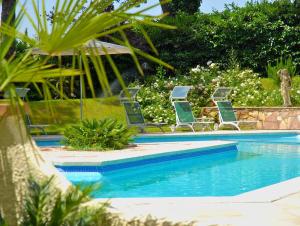 a group of chairs sitting next to a swimming pool at Eurogarden Hotel in Rome