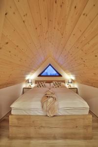 a bedroom with a large bed with a window at Apartamenty Kościelisko in Kościelisko