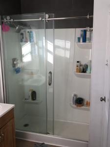 a shower with a glass door in a bathroom at Timen house in North Hollywood