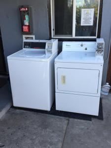 two white appliances are sitting next to a window at Timen house in North Hollywood