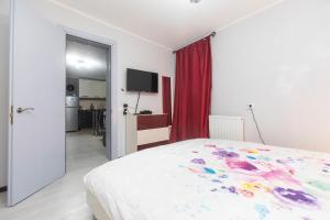 a bedroom with a bed and a red curtain at Apartment Ritz Street in Tbilisi City