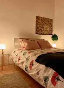 a bedroom with a bed with a comforter at Casa da Pedra - Aljezur, always the sun in Aljezur