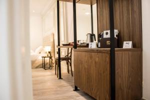 a room with a desk and a table with a chair at 50th Guest House in Vittoriosa