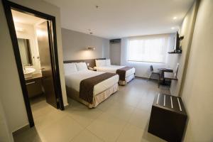 Giường trong phòng chung tại Hotel Ojos Del Rio