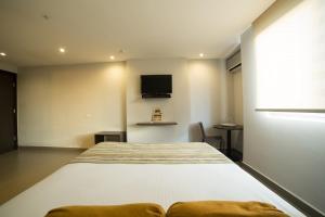 Giường trong phòng chung tại Hotel Ojos Del Rio