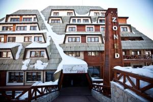 un edificio con la neve sopra di esso di NEW!!! 4 stars apartment!!! a Kopaonik