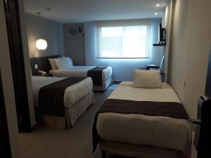 Giường trong phòng chung tại Hotel Ojos Del Rio