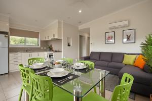 a living room with a table and a couch at BIG4 Launceston Holiday Park in Launceston