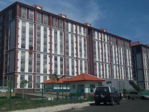 an old car parked in front of a large building at Sri Nabalu Apartment Platinum Putatan in Kota Kinabalu