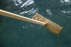 a wooden stick floating in the water at Oshuku Onsen Kagasuke in Shizukuishi