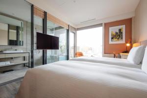 a hotel room with a large bed and a large mirror at Parkview Taipei in Taipei