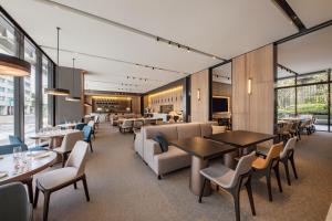 a dining room with tables and chairs and a restaurant at Parkview Taipei in Taipei