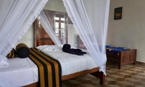 A bed or beds in a room at Sun View Resort Kithalella