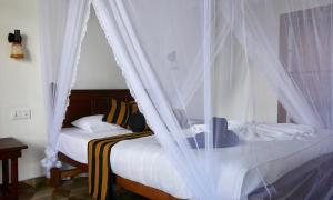 A bed or beds in a room at Sun View Resort Kithalella