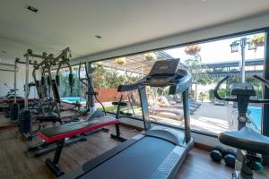 a gym with cardio equipment and a large window at Siam Piman Hotel in Bangkok