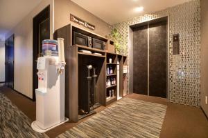 a room with a refrigerator and a walk in shower at The Grandeur Hotel in Kawasaki