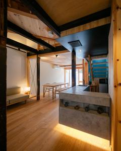 a kitchen and dining room with a table at Machiya Hotel YANAGI in Kyoto