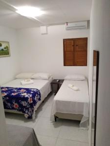 Giường trong phòng chung tại Pousada Praia Bela Maceió